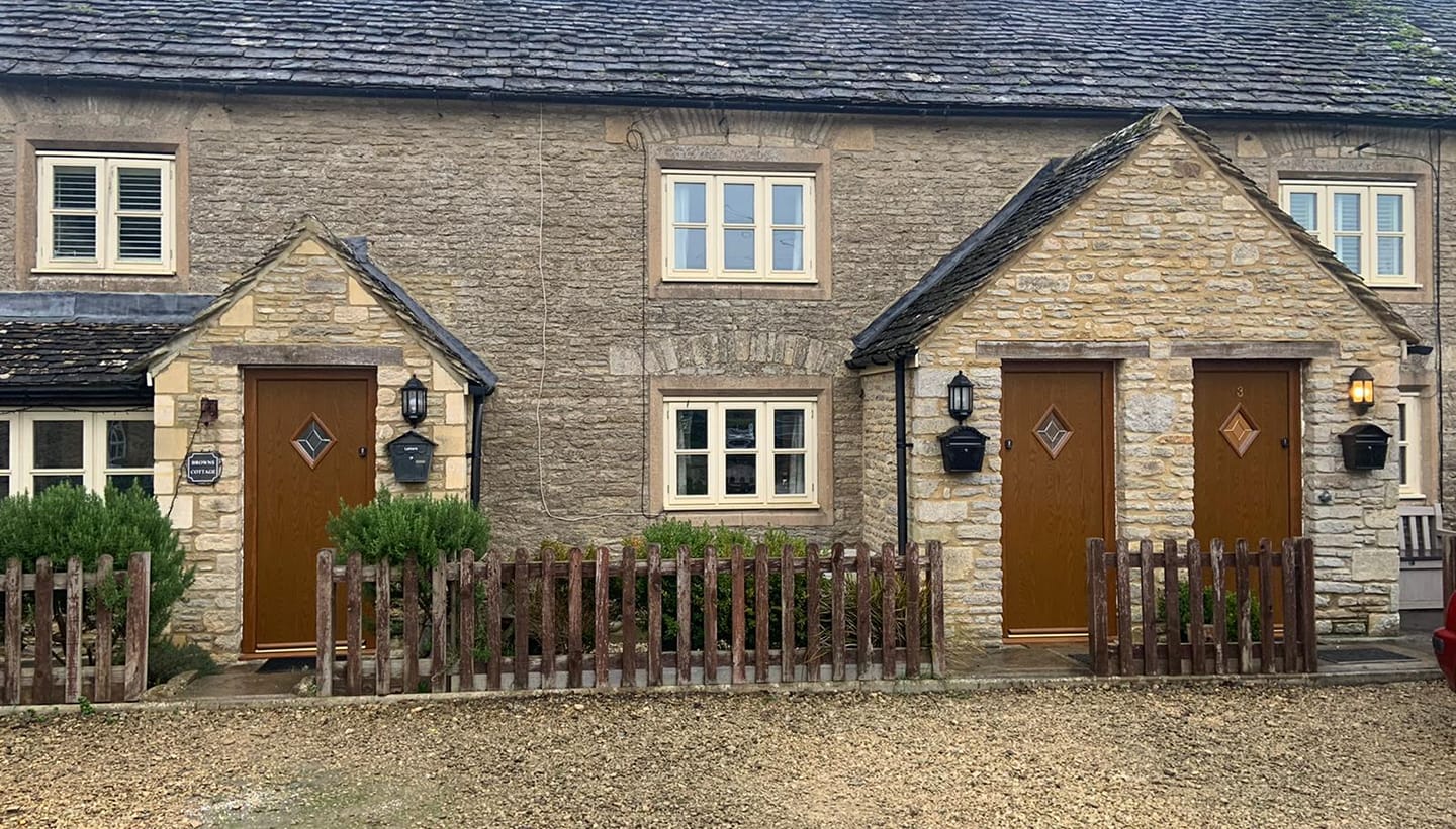 Cotswold stone cottages with oak composite door replacements.